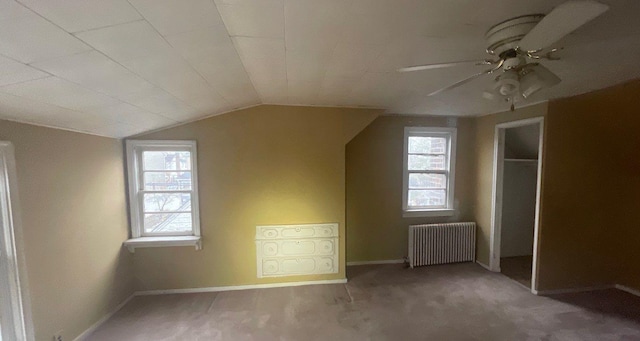 bonus room with ceiling fan, carpet floors, radiator, and vaulted ceiling