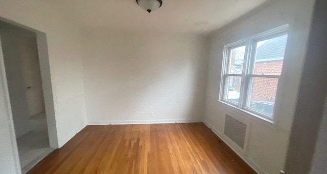 spare room with hardwood / wood-style floors