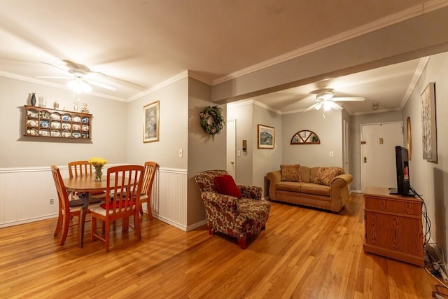 dining space with light hardwood / wood-style floors, ceiling fan, and crown molding