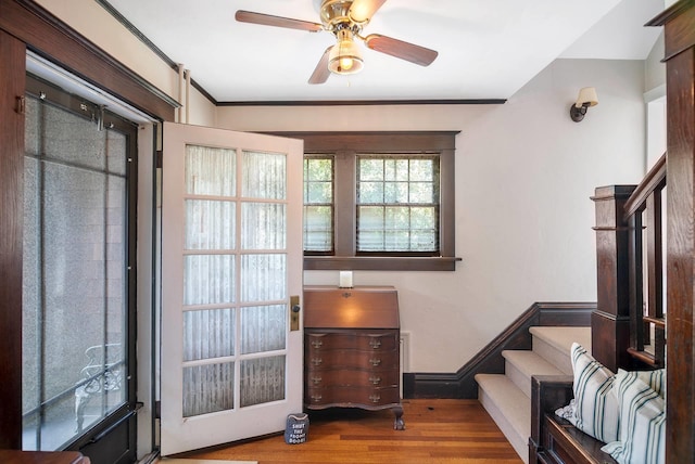 entrance foyer featuring ceiling fan, light hardwood / wood-style floors, and ornamental molding