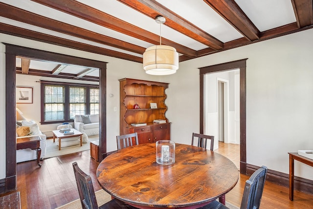 dining room featuring hardwood / wood-style floors and beam ceiling