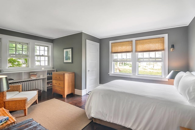 bedroom with radiator, dark wood-type flooring, and ornamental molding