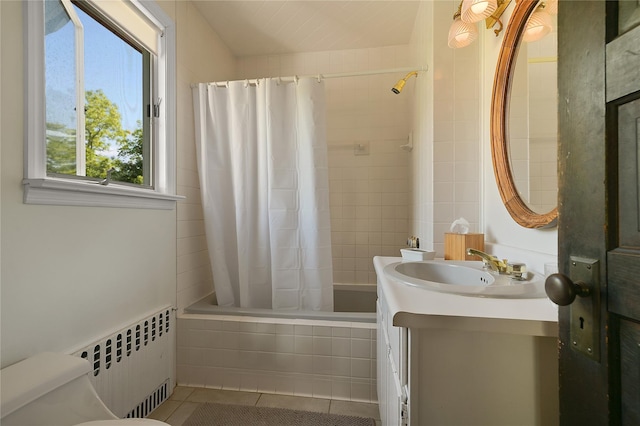 full bathroom with radiator, vanity, shower / tub combo with curtain, tile patterned flooring, and toilet