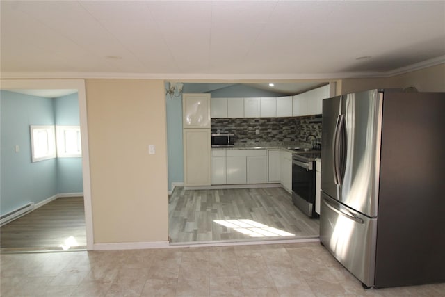 kitchen featuring sink, tasteful backsplash, light hardwood / wood-style floors, white cabinetry, and stainless steel appliances