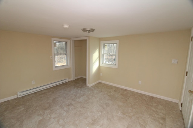 spare room with a baseboard heating unit