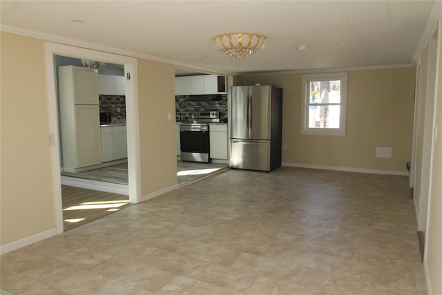 kitchen featuring decorative backsplash, appliances with stainless steel finishes, ornamental molding, an inviting chandelier, and white cabinets