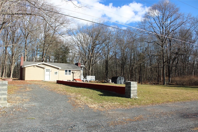 exterior space featuring a storage unit and a lawn