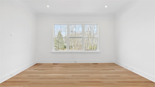 unfurnished room featuring crown molding and light hardwood / wood-style floors