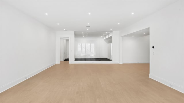 spare room with light hardwood / wood-style flooring