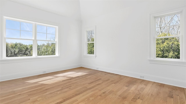 spare room with a healthy amount of sunlight and light wood-type flooring