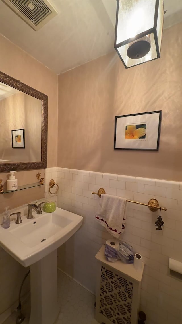 bathroom with tile patterned floors and tile walls