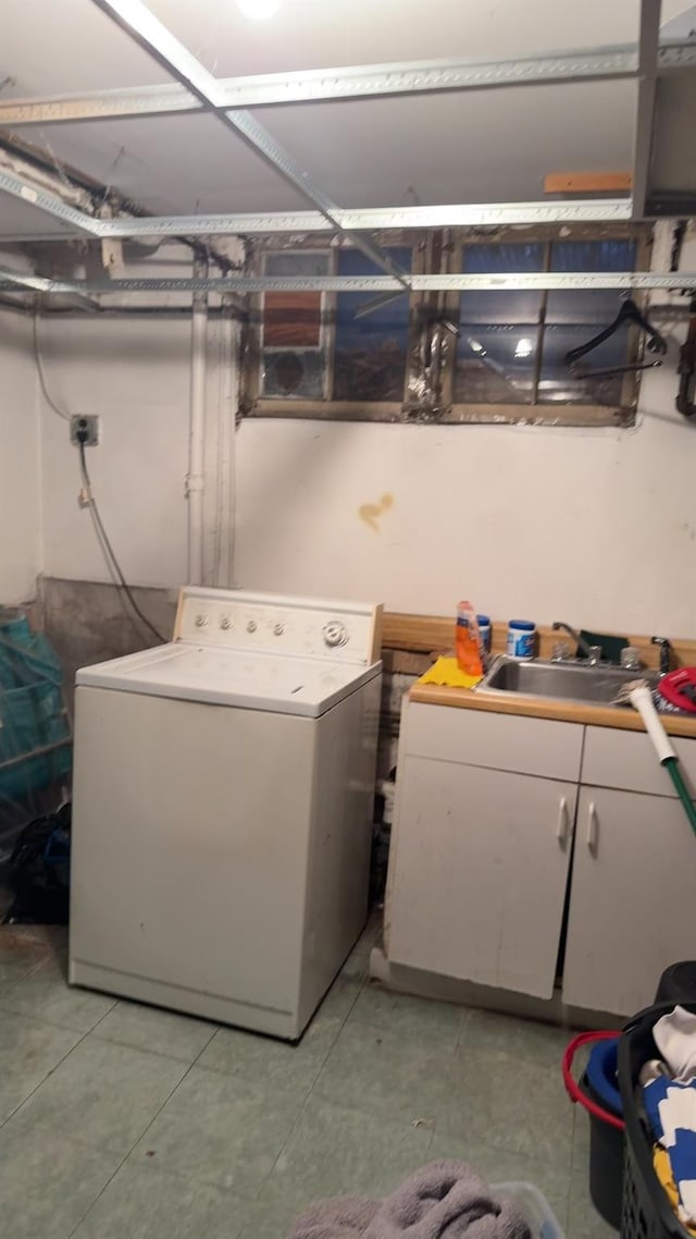 clothes washing area featuring cabinets, separate washer and dryer, and sink