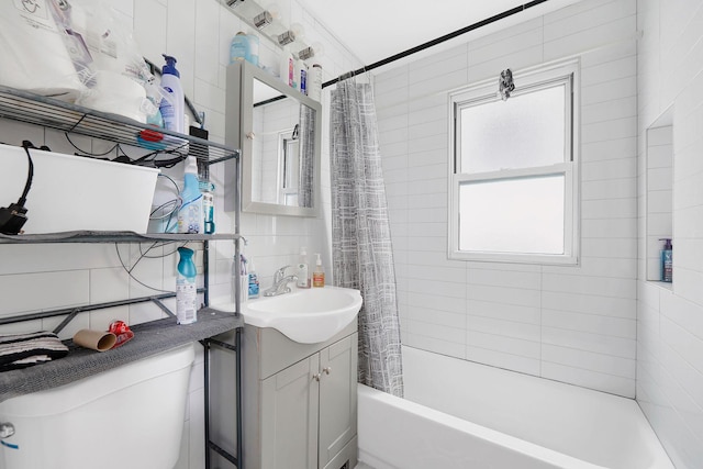 full bathroom with decorative backsplash, shower / bath combo, vanity, tile walls, and toilet