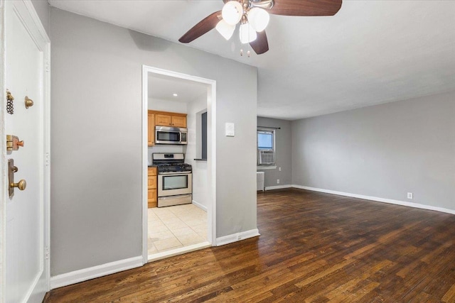 unfurnished living room featuring ceiling fan and wood-type flooring