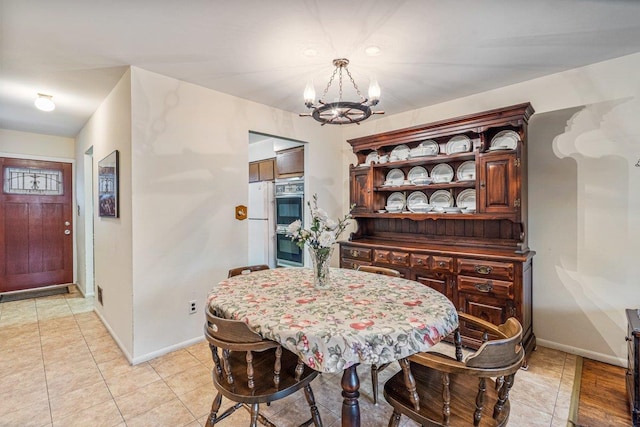 tiled dining area featuring a notable chandelier