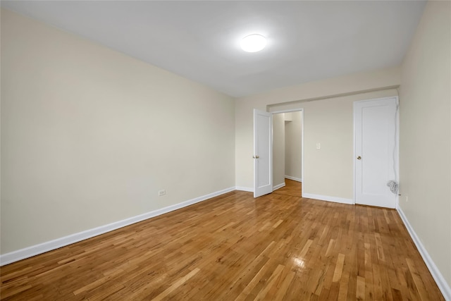 unfurnished bedroom with light hardwood / wood-style floors and a closet