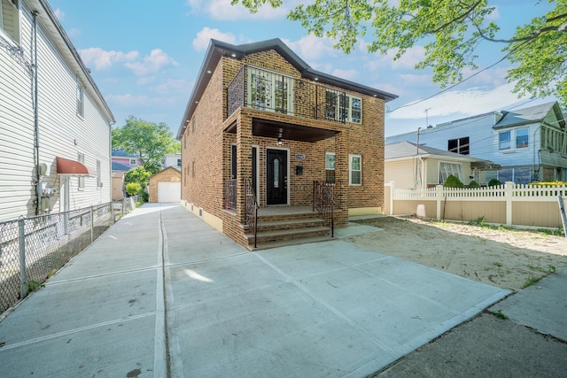 115-42 Inwood St, Jamaica, NY 11436 - rear view of house with brick siding, an outbuilding, and a garage