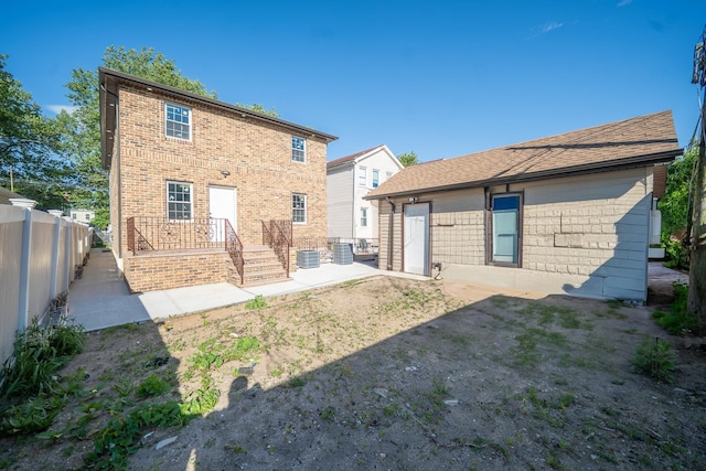 115-42 Inwood St, Jamaica, NY 11436 - back of house featuring brick siding, a patio, and central AC unit