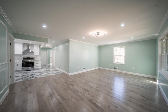 115-42 Inwood St, Jamaica, NY 11436 - unfurnished living room with light wood-style flooring, baseboards, recessed lighting, ornamental molding, and a premium fireplace