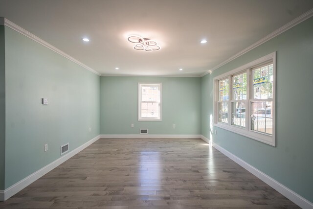 115-42 Inwood St, Jamaica, NY 11436 - unfurnished room featuring healthy amount of natural light, wood finished floors, crown molding, recessed lighting, and baseboards