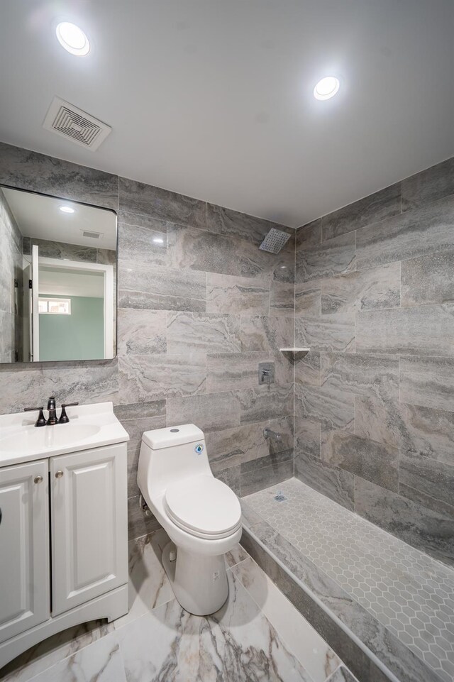 115-42 Inwood St, Jamaica, NY 11436 - full bathroom with tiled shower, toilet, vanity, marble finish floors, and tile walls