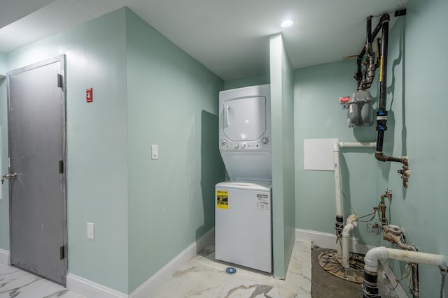 115-42 Inwood St, Jamaica, NY 11436 - laundry area with stacked washer / drying machine, light marble finish floors, and baseboards