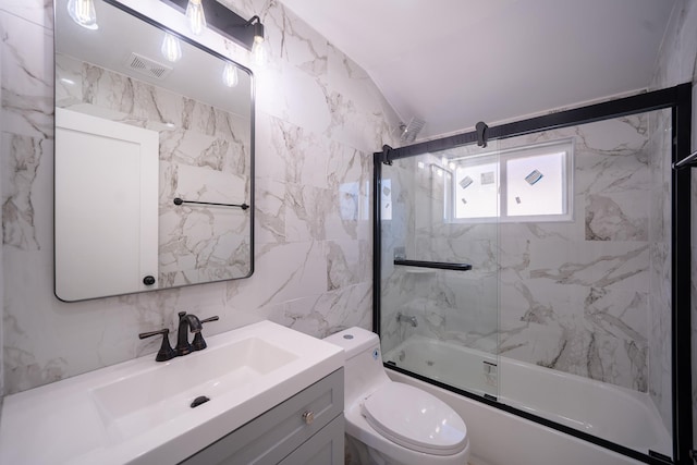 115-42 Inwood St, Jamaica, NY 11436 - full bath with tile walls, bath / shower combo with glass door, toilet, and vanity