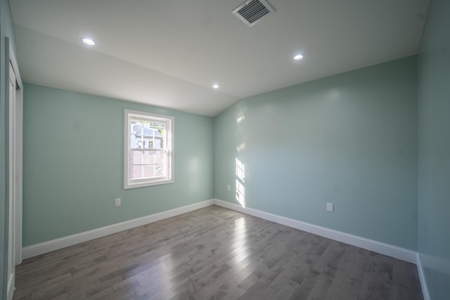 115-42 Inwood St, Jamaica, NY 11436 - empty room featuring wood finished floors, baseboards, recessed lighting, and lofted ceiling