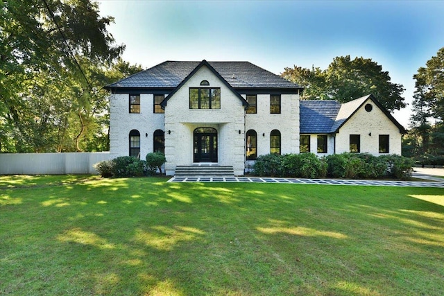 french provincial home featuring a front yard