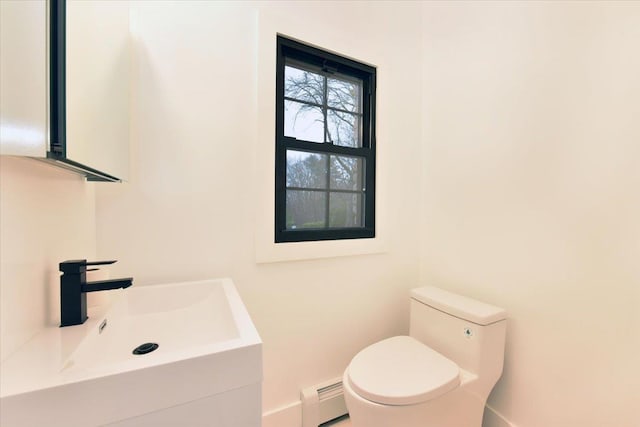 bathroom featuring vanity, a baseboard radiator, and toilet