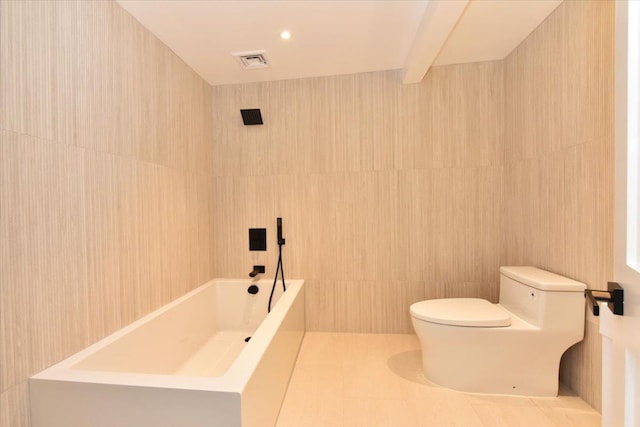 bathroom with tile patterned floors, beamed ceiling, tile walls, and toilet