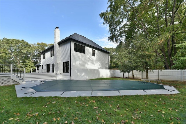 view of property exterior with a patio, a pool side deck, and a lawn