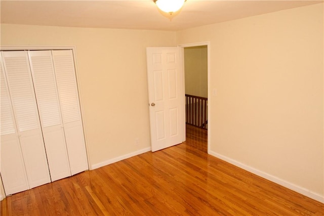 unfurnished bedroom featuring a closet and hardwood / wood-style floors