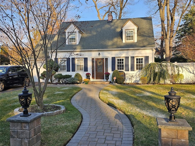 cape cod-style house with a front lawn