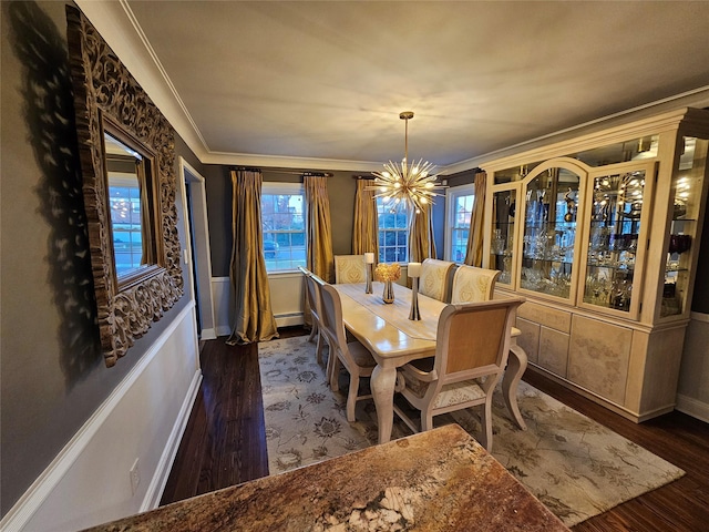 dining space featuring a baseboard heating unit, crown molding, dark hardwood / wood-style floors, and an inviting chandelier