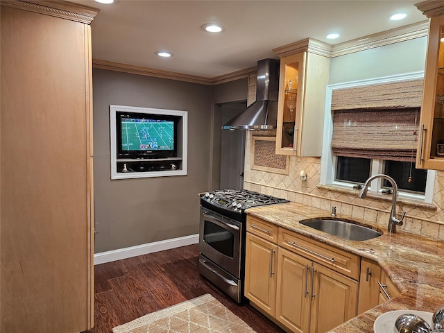 kitchen with ornamental molding, wall chimney exhaust hood, stainless steel gas range, sink, and light brown cabinets