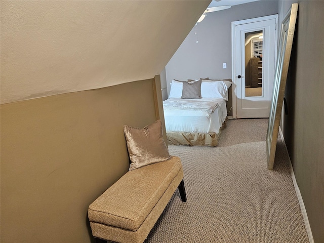 bedroom with ceiling fan, light colored carpet, and lofted ceiling