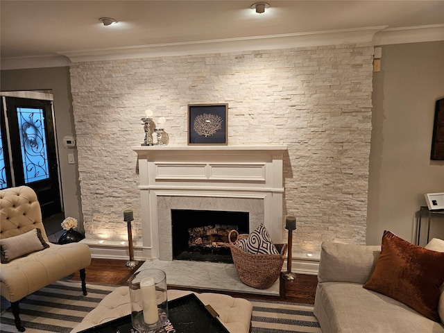 living area featuring hardwood / wood-style floors and ornamental molding