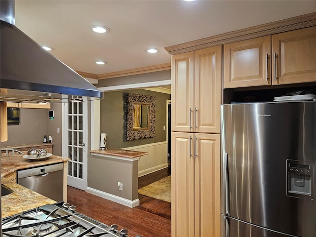 kitchen with light stone countertops, dark wood-type flooring, stainless steel appliances, crown molding, and island range hood