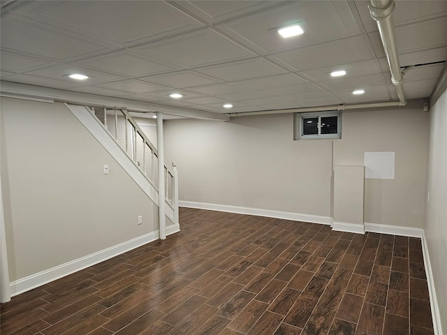 basement with dark hardwood / wood-style floors