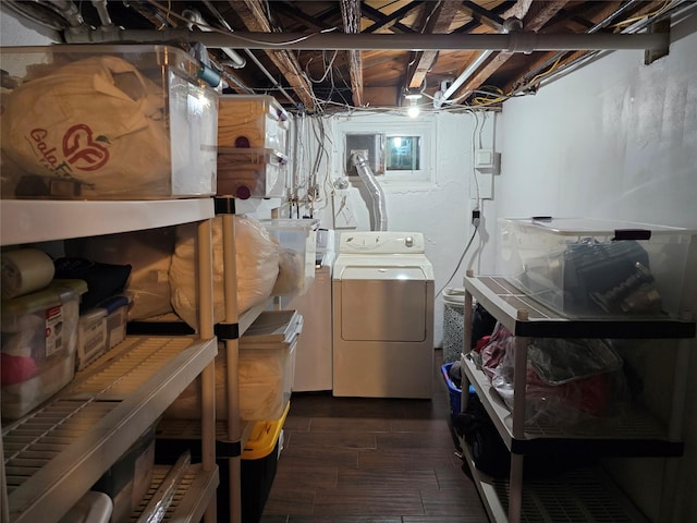 laundry room with hardwood / wood-style flooring and washer / dryer