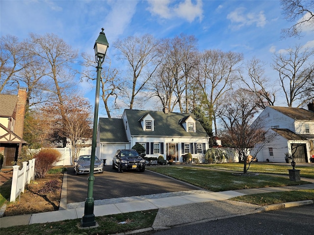 new england style home featuring a garage and a front yard