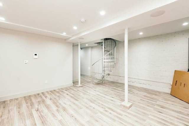 finished basement featuring stairs, recessed lighting, baseboards, and wood finished floors