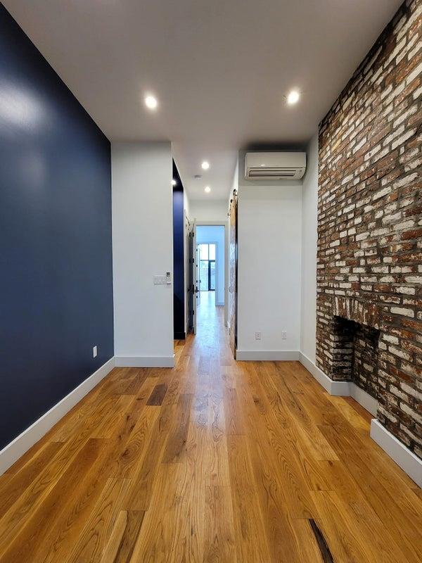 corridor with recessed lighting, light wood-style flooring, baseboards, and a wall mounted AC