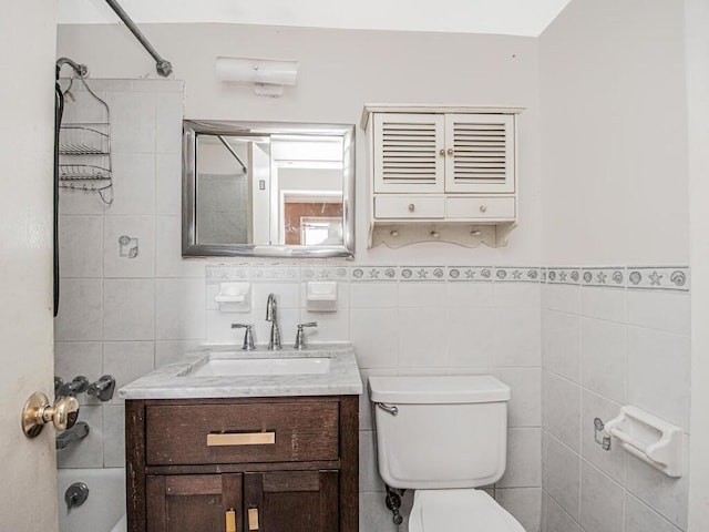 full bathroom with vanity, bathtub / shower combination, tile walls, and toilet