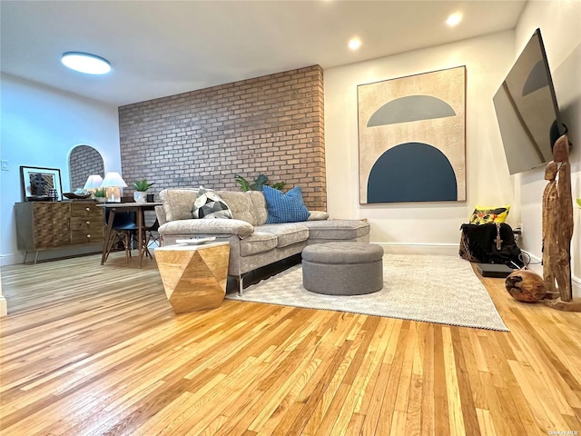 interior space featuring light hardwood / wood-style floors and brick wall