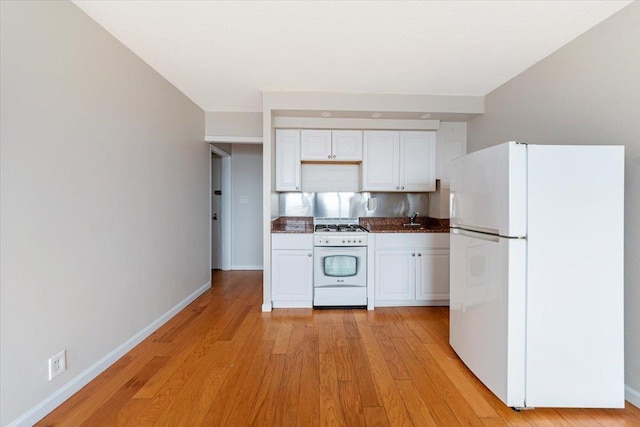 kitchen with light wood-type flooring, white appliances, and white cabinetry