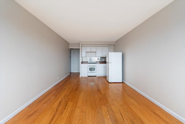 unfurnished living room with light hardwood / wood-style flooring