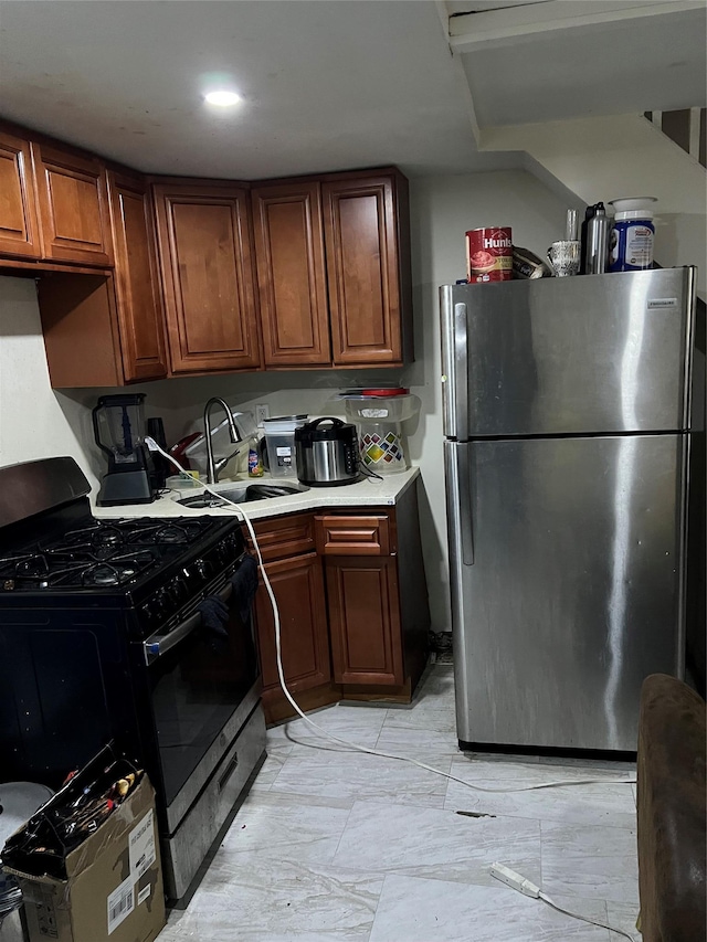 kitchen with stainless steel fridge, sink, and black gas stove