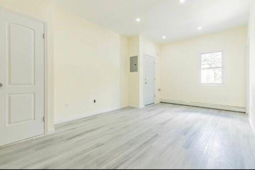 88 Taft Ave, Staten Island, NY 10301 - spare room featuring light wood-type flooring, electric panel, and recessed lighting